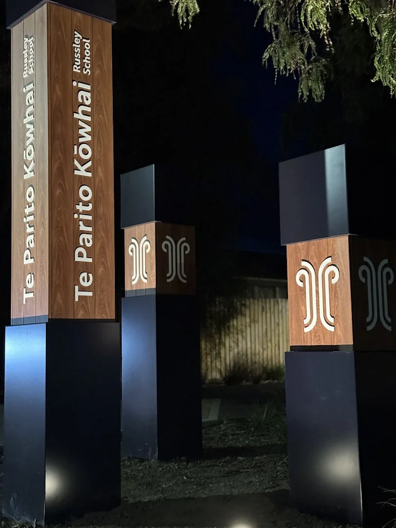 Te Parito Kōwhai — the three poles lit from below at night
